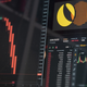 A photo of a screen showing the Luna and Terra symbol with graphs showing the price crashing.